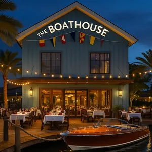 A small ship sails along the water in front of The BOATHOUSE at Disney Springs
