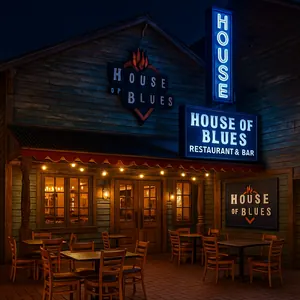 Three men dining outside at a table on the patio near House of Blues Restaurant & Bar