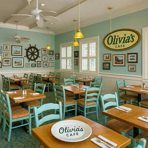 Model ship in a display case near tables and chairs at Olivia's Café